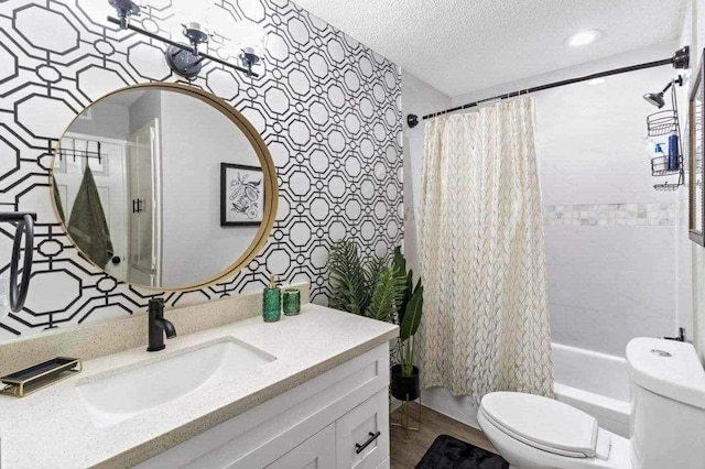 full bathroom with vanity, toilet, a textured ceiling, and shower / tub combo with curtain