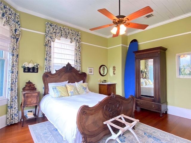 bedroom with hardwood / wood-style flooring, ceiling fan, and ornamental molding