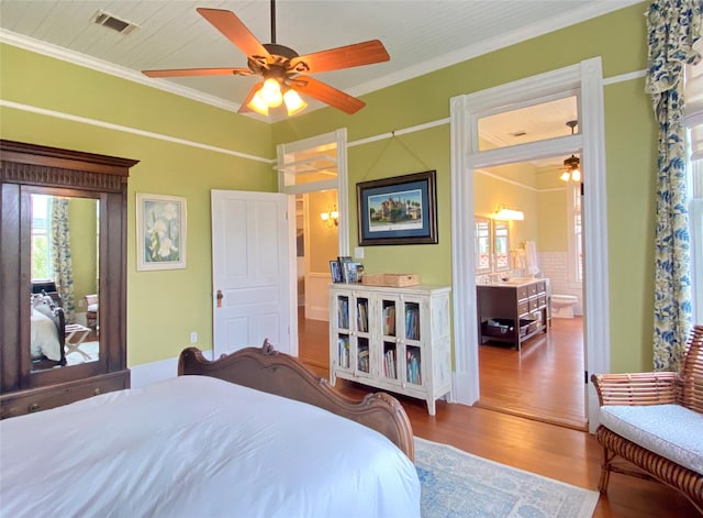 bedroom featuring multiple windows, wood-type flooring, ceiling fan, and crown molding