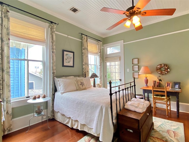 bedroom with ceiling fan, hardwood / wood-style floors, and ornamental molding