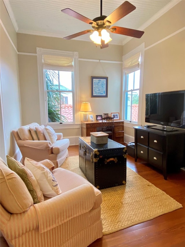 living room with crown molding, ceiling fan, hardwood / wood-style floors, and a healthy amount of sunlight