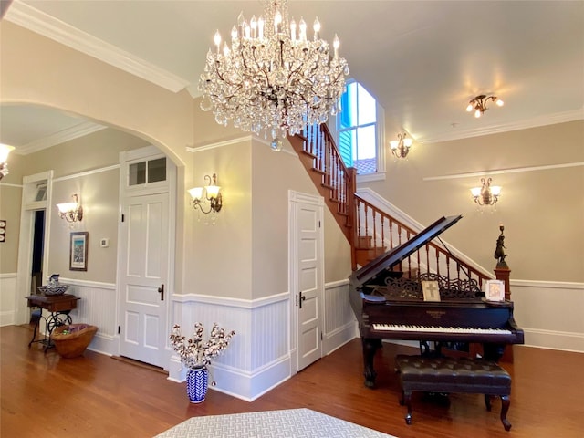 misc room featuring hardwood / wood-style floors, ornamental molding, and an inviting chandelier