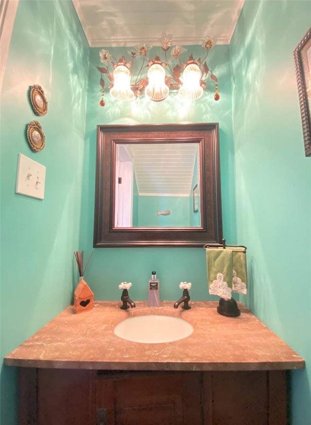 bathroom with vanity and ornamental molding