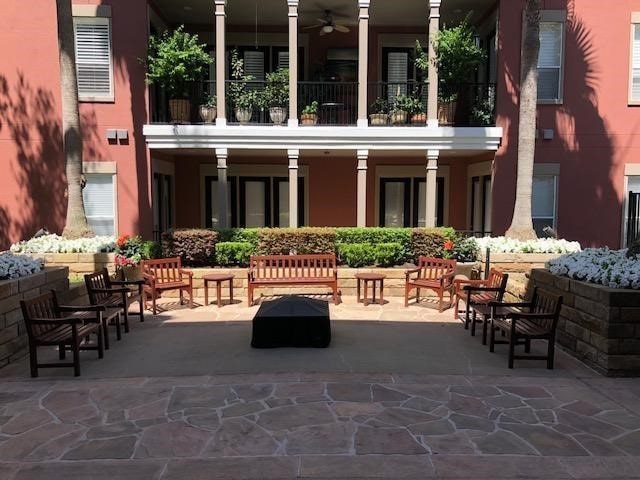 view of patio featuring ceiling fan and a balcony