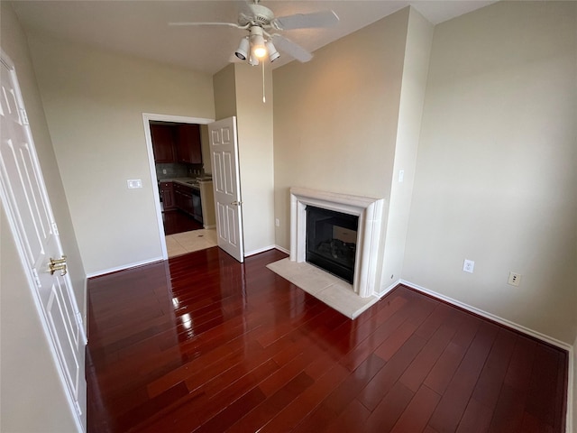 unfurnished living room featuring dark hardwood / wood-style floors and ceiling fan