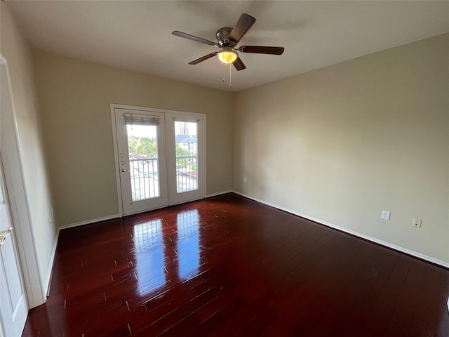 unfurnished room with ceiling fan and dark wood-type flooring