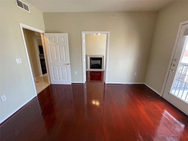 empty room featuring dark hardwood / wood-style flooring