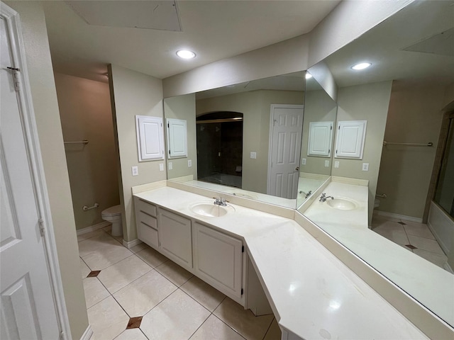 bathroom with tile patterned floors, vanity, toilet, and an enclosed shower