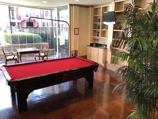 rec room featuring built in features, a wealth of natural light, and billiards