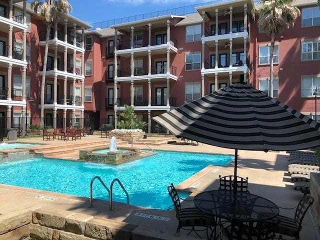 view of swimming pool featuring pool water feature