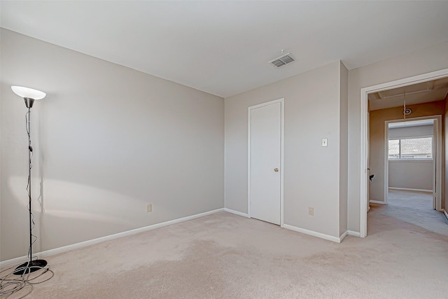 unfurnished bedroom featuring light carpet