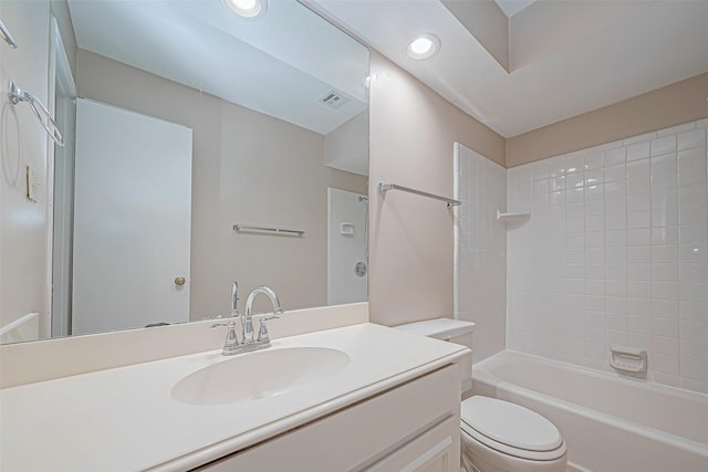 full bathroom featuring vanity, toilet, and tiled shower / bath