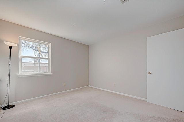 unfurnished room featuring light colored carpet