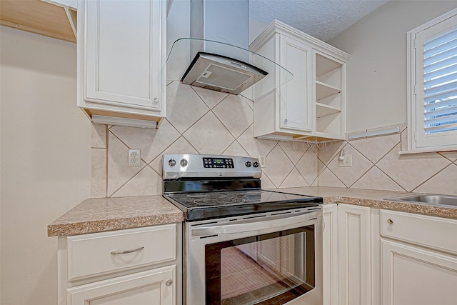 kitchen with a textured ceiling, white cabinetry, stainless steel electric stove, and range hood