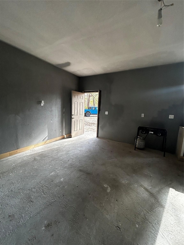 unfurnished room featuring concrete flooring