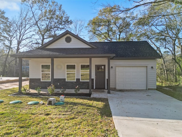 view of front of house featuring covered porch, a garage, and a front yard