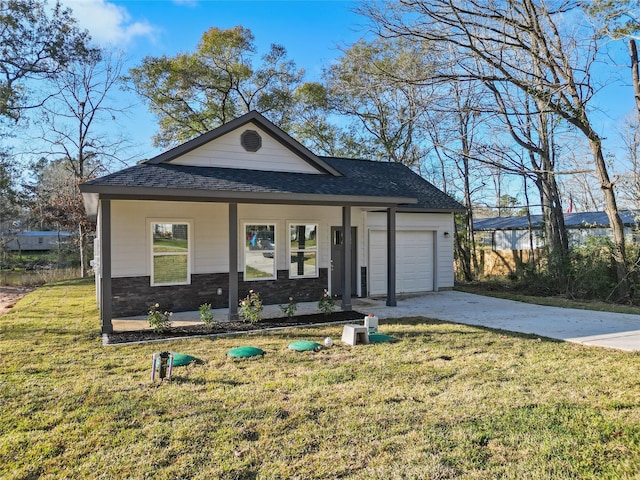 view of front of house featuring covered porch, a front yard, and a garage