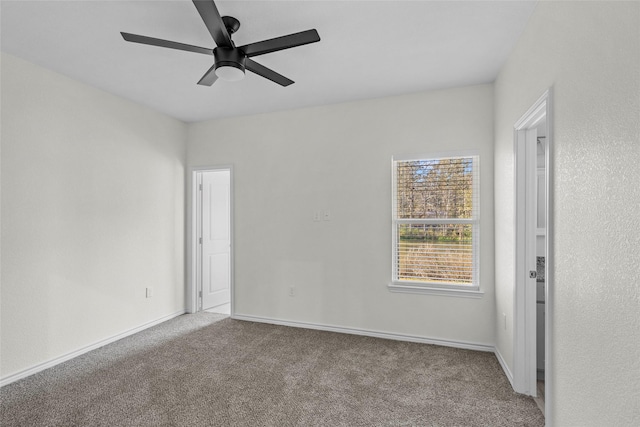 carpeted spare room with ceiling fan