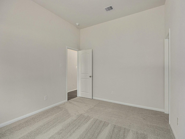 unfurnished room with carpet and a high ceiling