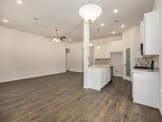 kitchen featuring decorative backsplash, white cabinets, and decorative light fixtures