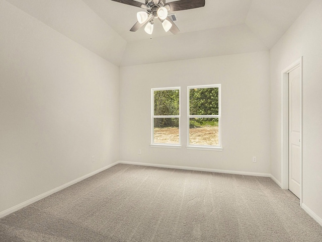 carpeted spare room featuring ceiling fan and vaulted ceiling