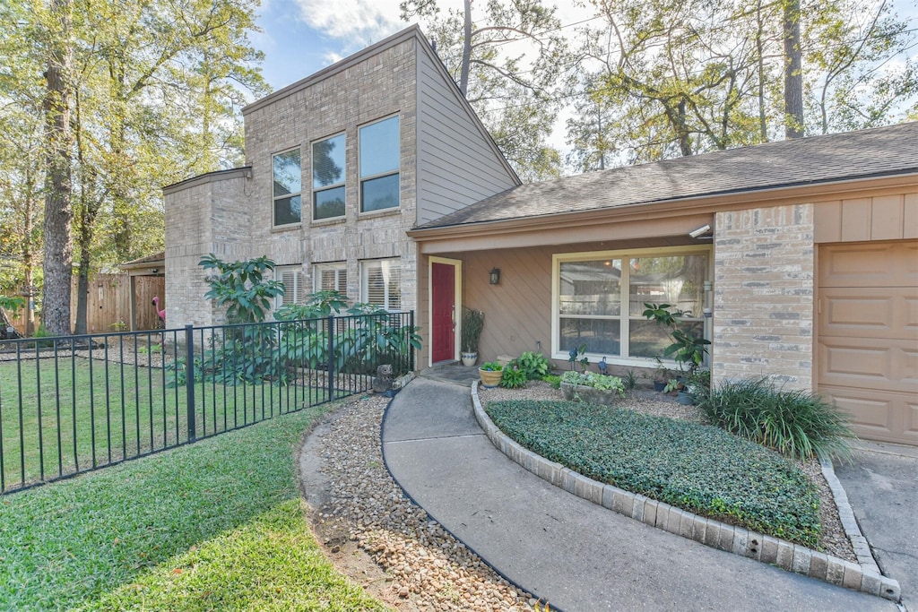 view of front of property with a garage and a front lawn