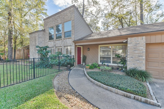 view of front of property with a garage and a front lawn