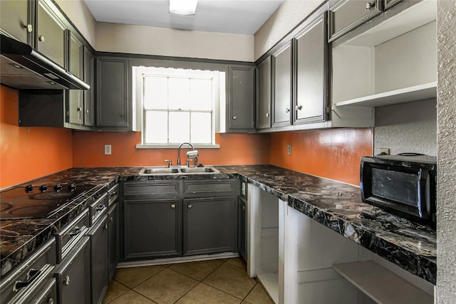 kitchen featuring cooktop, sink, and light tile patterned floors