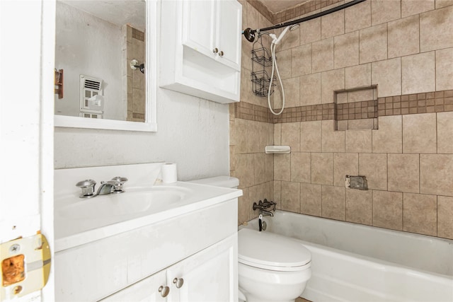 full bathroom featuring toilet, vanity, and tiled shower / bath