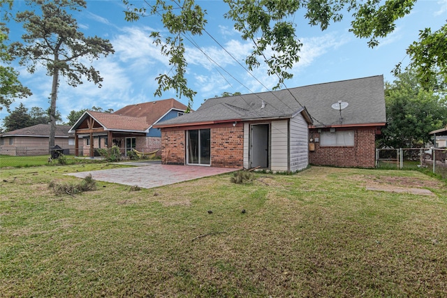 back of property featuring a patio and a lawn