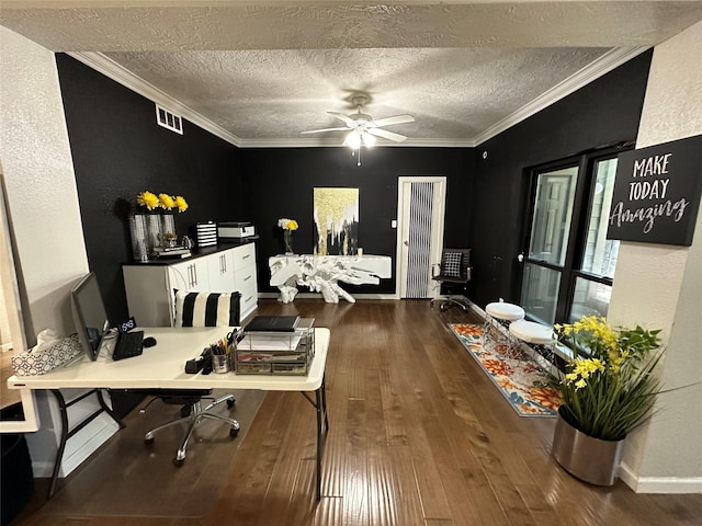 office area featuring a textured ceiling, dark wood-type flooring, ceiling fan, and crown molding