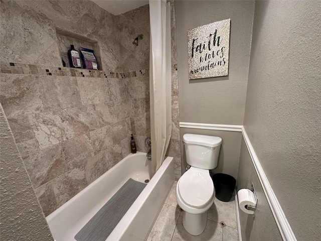 bathroom featuring shower / tub combo and toilet