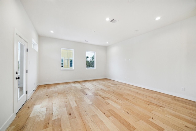 spare room featuring light hardwood / wood-style flooring