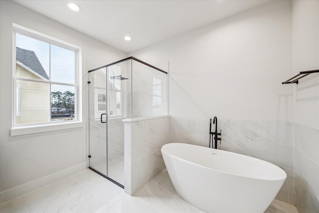 bathroom featuring independent shower and bath