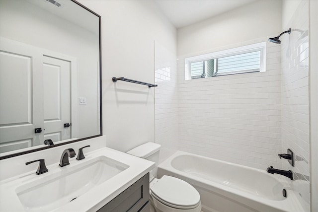 full bathroom with toilet, tiled shower / bath, and vanity