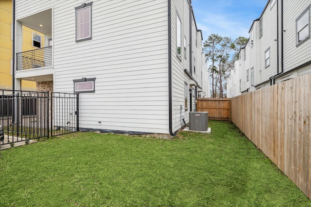 view of side of home with a yard and cooling unit