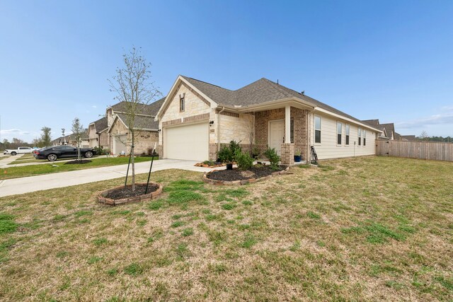 view of front of house with a garage and a front lawn