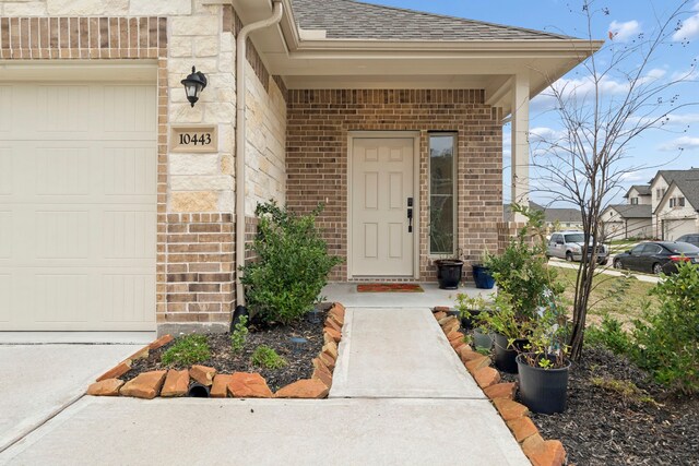 doorway to property with a garage