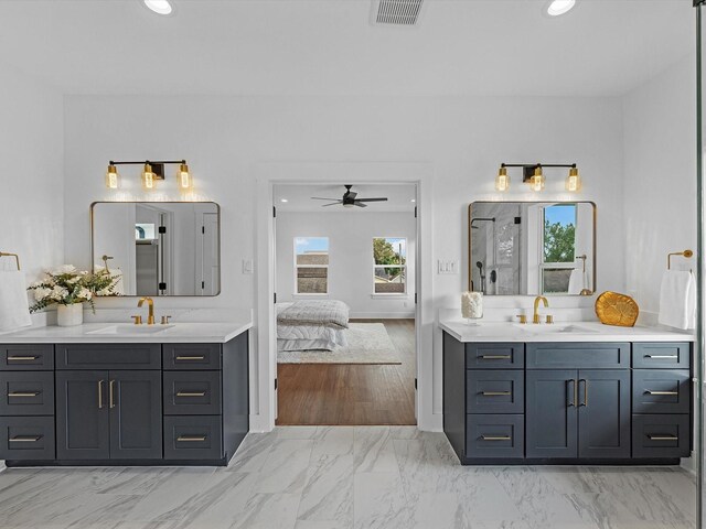 bathroom featuring ceiling fan, vanity, and walk in shower