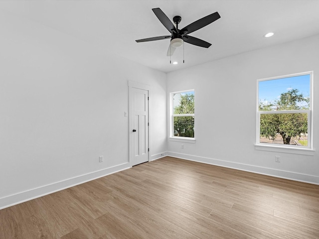 empty room with light hardwood / wood-style floors and ceiling fan