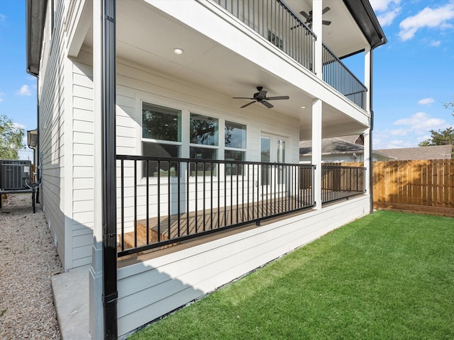 exterior space featuring a lawn, ceiling fan, a balcony, and central AC unit