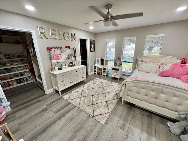 bedroom featuring ceiling fan, wood-type flooring, and a closet