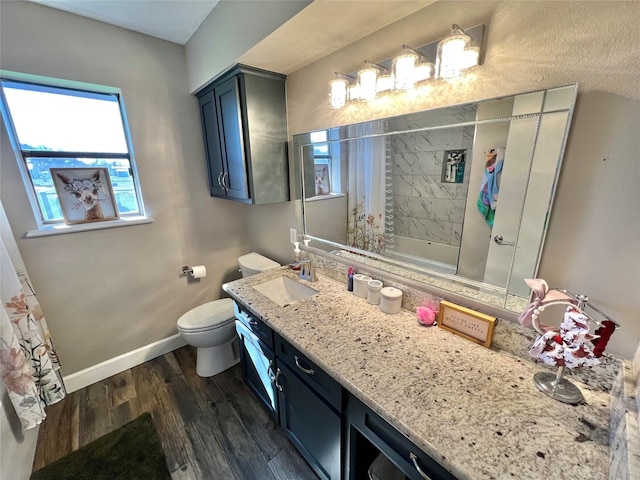 bathroom with wood-type flooring, vanity, and toilet