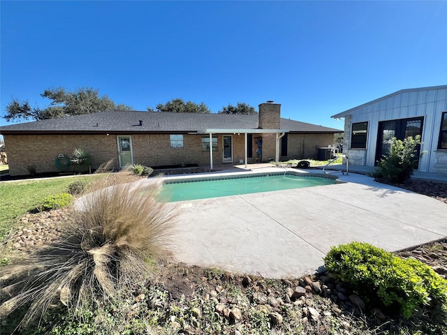 view of pool featuring a patio and central AC