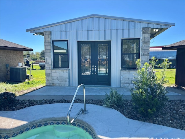 exterior space with central AC unit and french doors