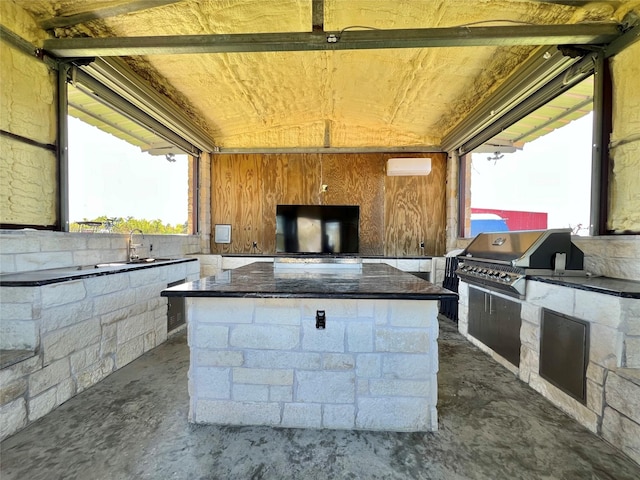 view of patio featuring grilling area, sink, area for grilling, and a wall mounted air conditioner