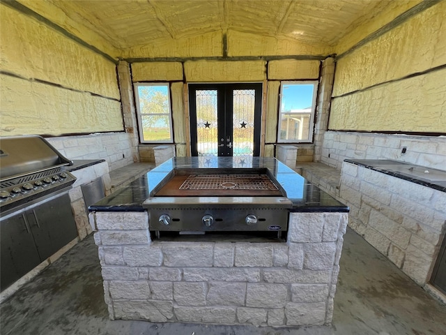 interior space featuring french doors and concrete floors