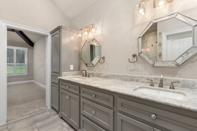 bathroom featuring tile patterned floors, vanity, and lofted ceiling