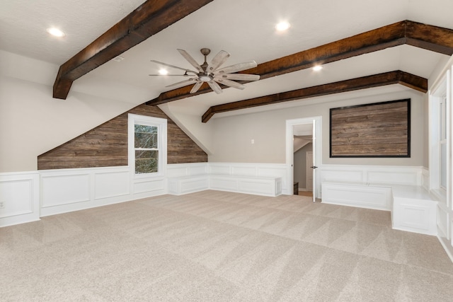 bonus room featuring lofted ceiling with beams, ceiling fan, and light carpet