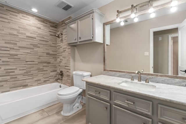 full bathroom with vanity, toilet, and tiled shower / bath